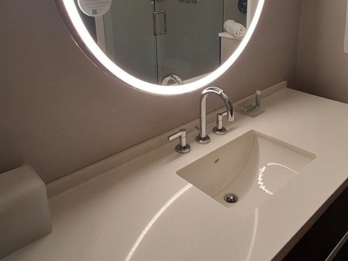 The sink and counter space of the hotel room
