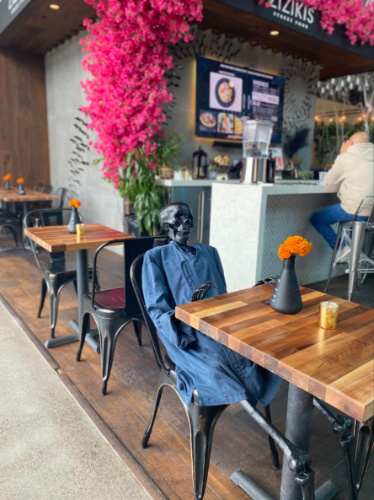 A skeleton sitting on a chair at Sky Deck at Del Mar Highlands Town Center
