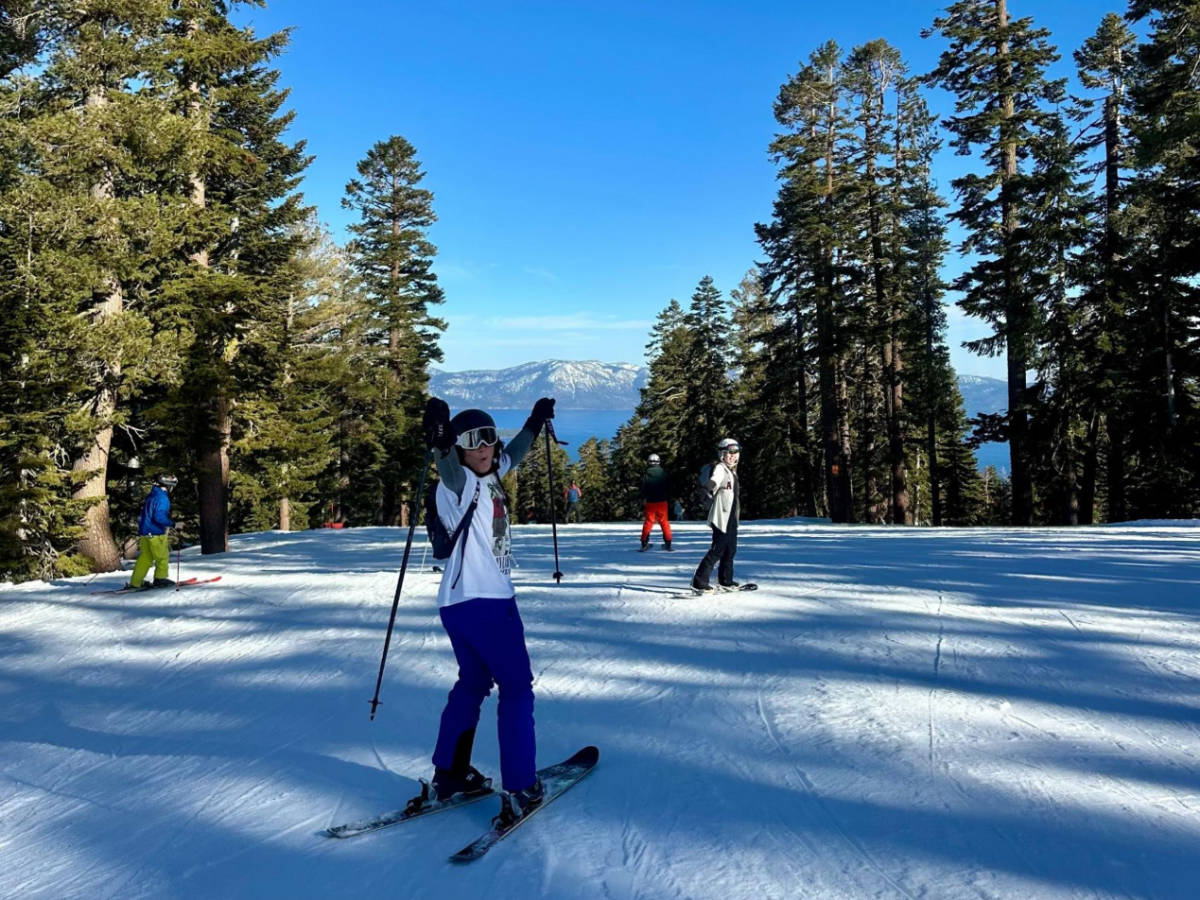The author's friend skiing in Northstar California Resort with a scenic view around