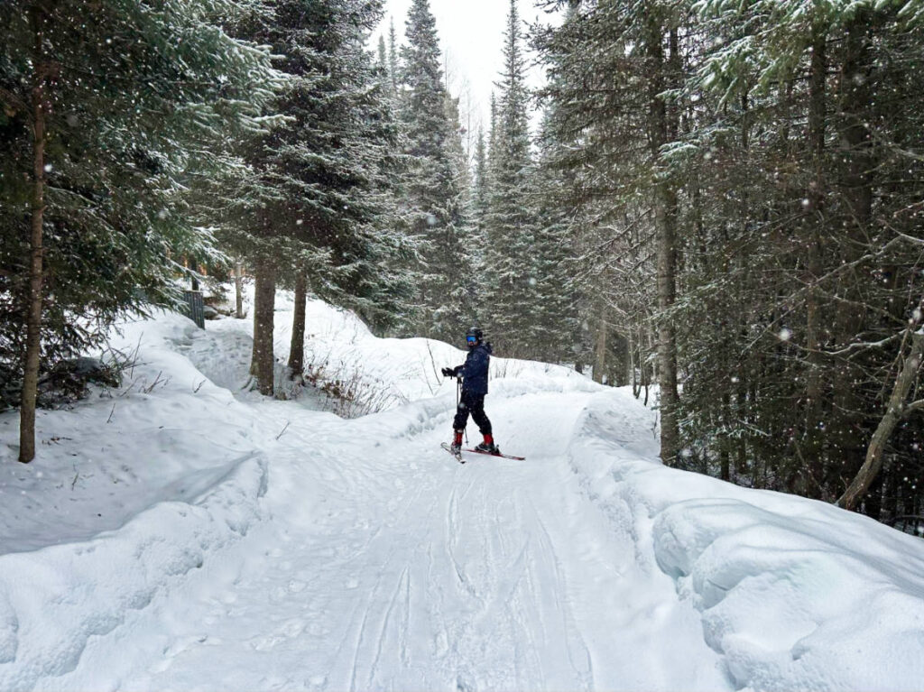 A man skiing on the trail in Sun Peaks