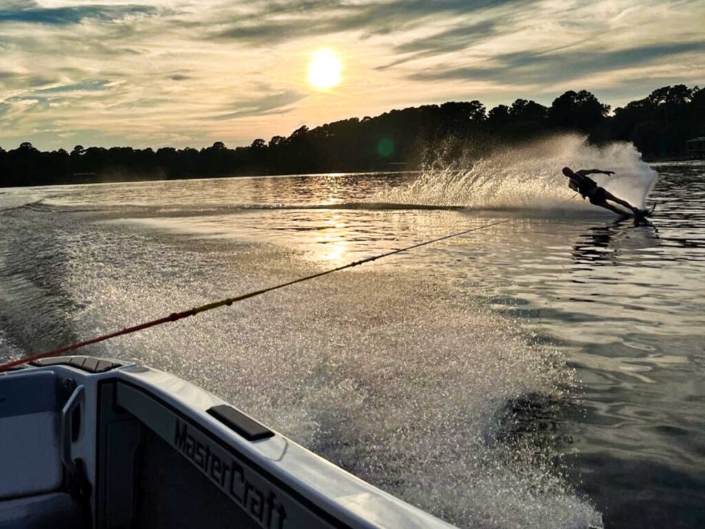 A man water skiing on Lake Conroe at sunset