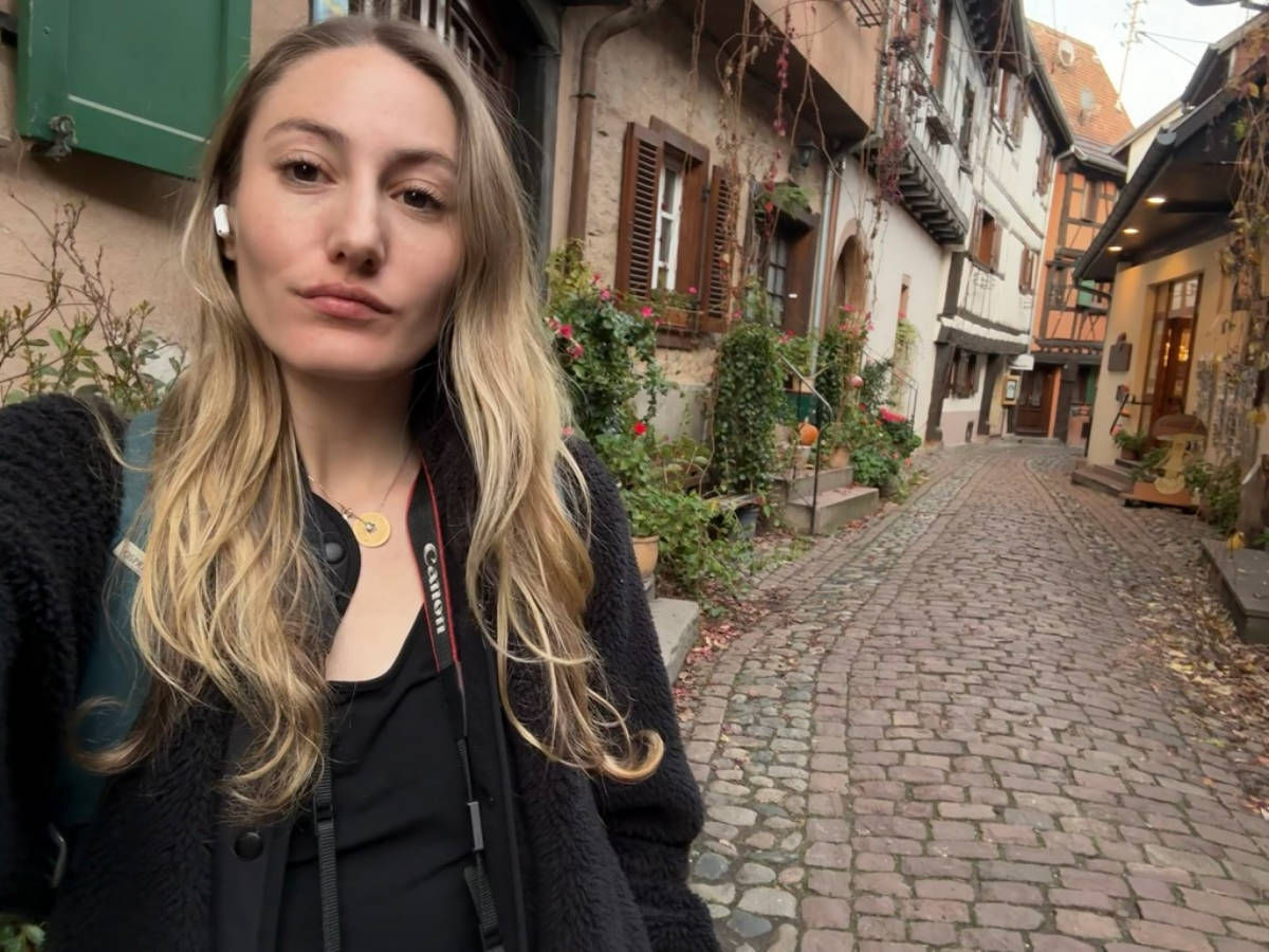 The author Sky Ariella, showing the cobbled street in Eguisheim