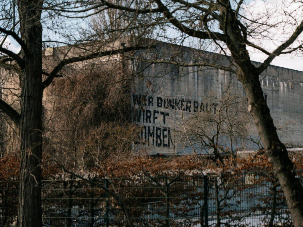 The slogan “Who builds bunkers drops bombs.” on the exterior of Berlin Story Bunker