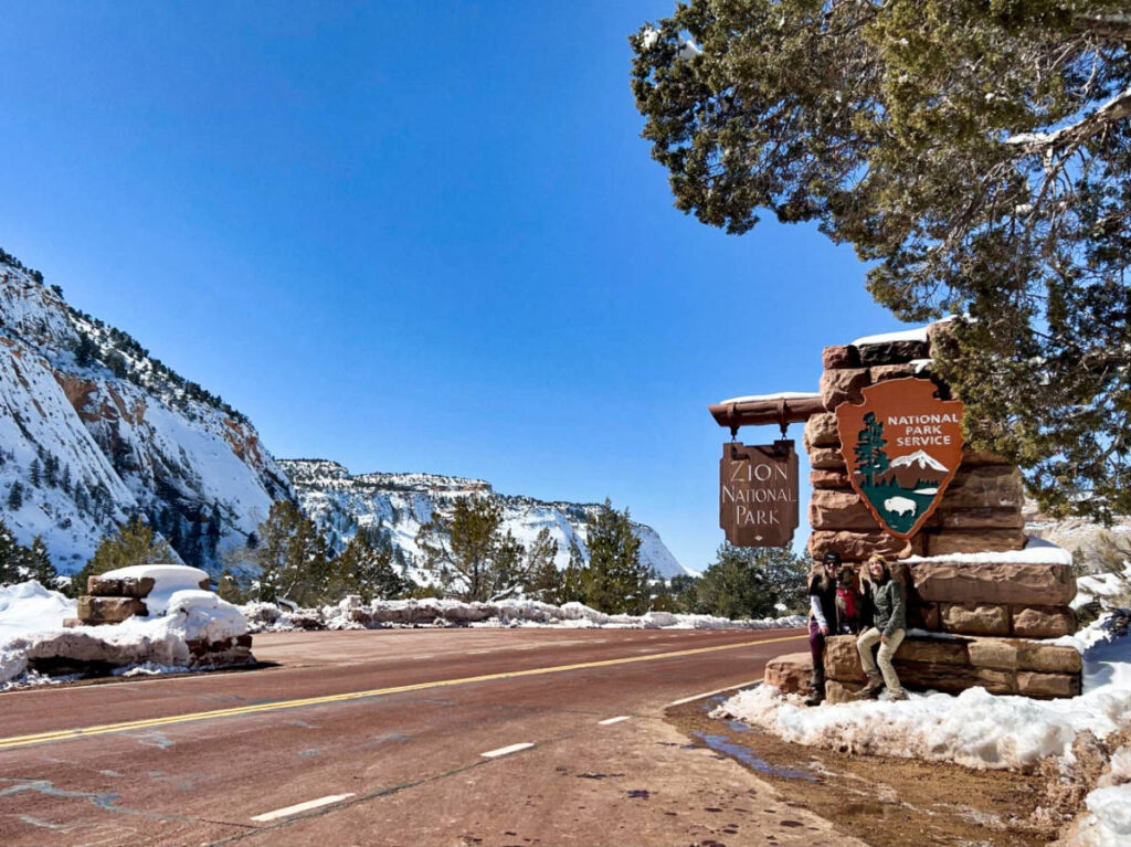 View of the signage of Zion National Park and the snow around