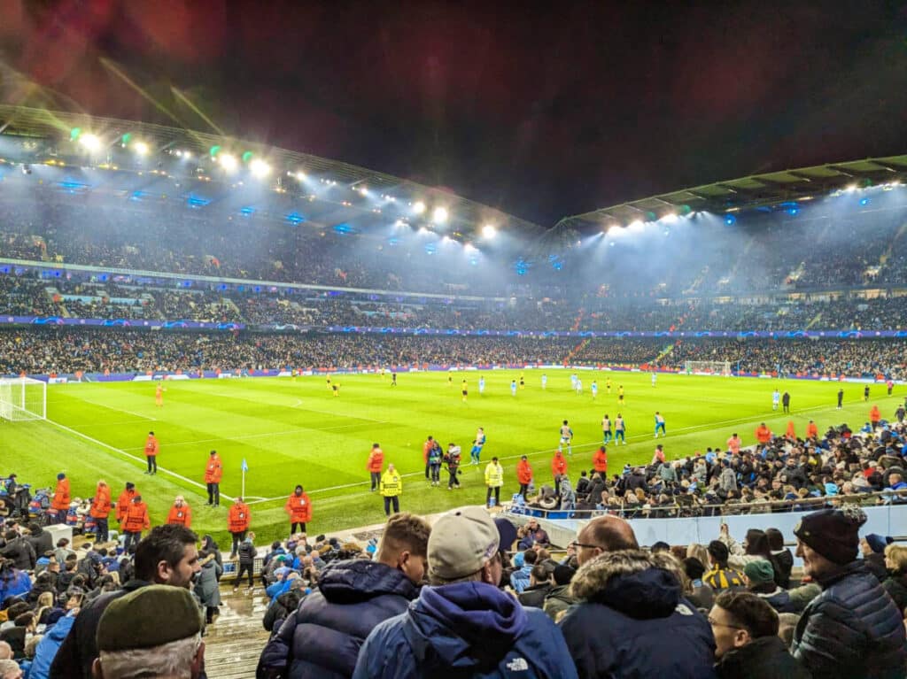 View of the crowd watching a soccer game inside a stadium in Manchester
