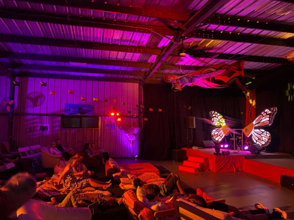 People in the Sonic Butterfly with art installations around