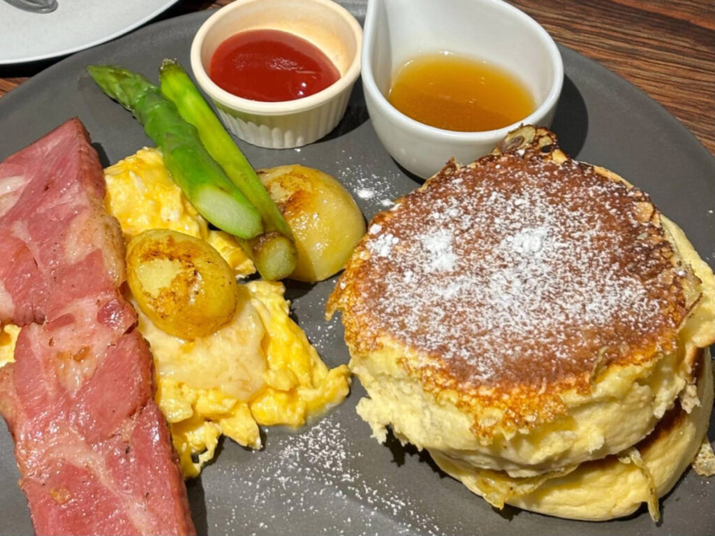 Souffle Pancakes with egg and bacon served on a plate