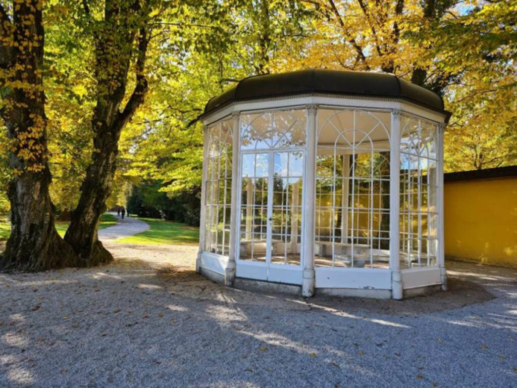 View of the Sound of Music gazebo under a tree at Hellbrunn Palace