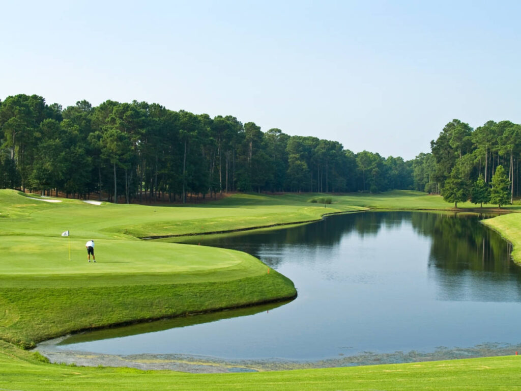 A lone golfer at the South Carolina golf course near the lake