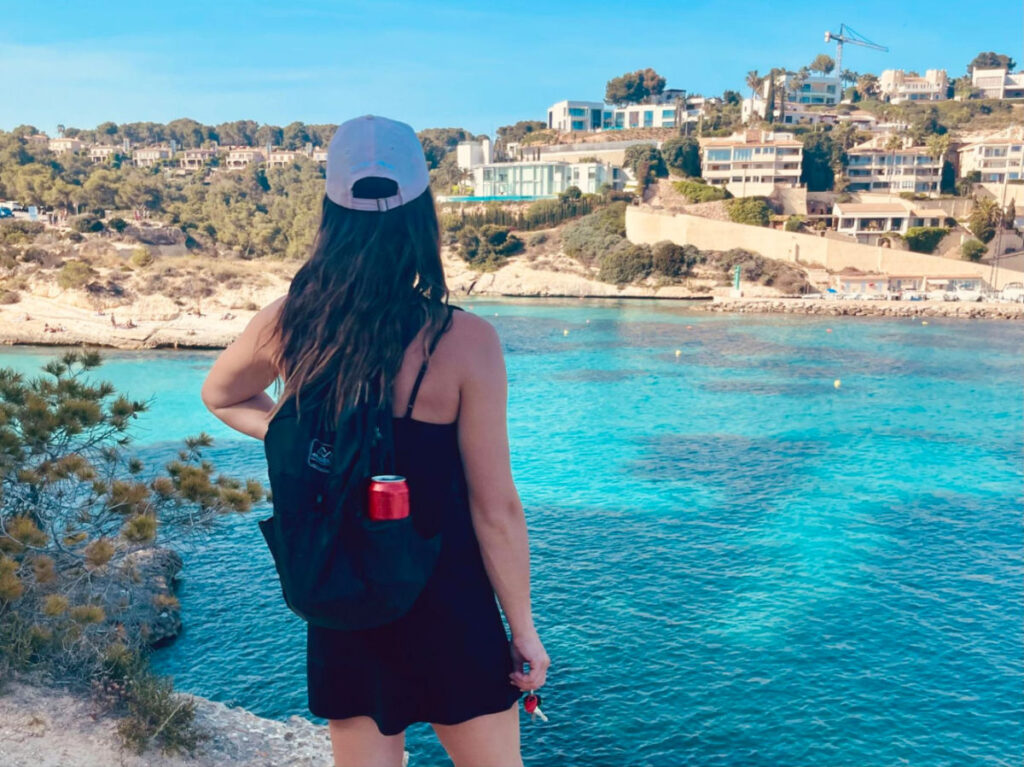 Travel Lemming writer Betty in black dress  admiring the water on Spain's southern coast