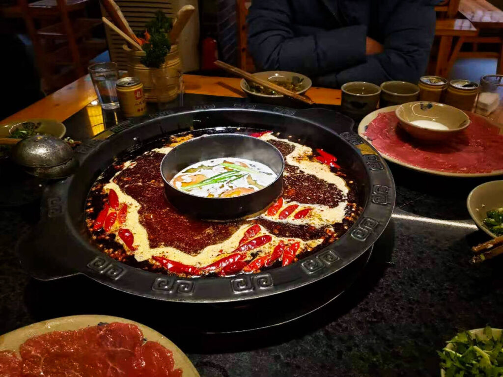 A spicy hot pot with an inner ring of non-spicy broth