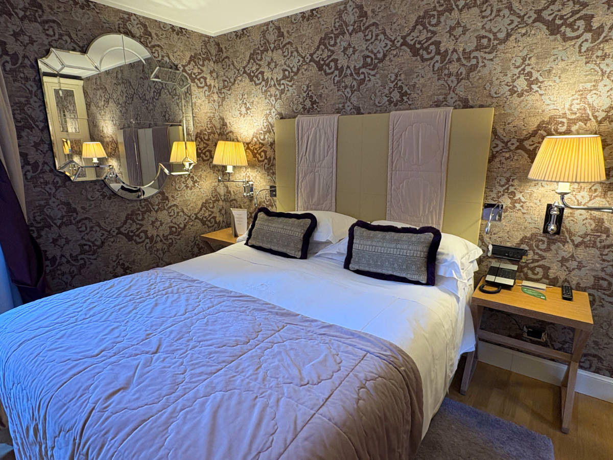 The bed and bedside tables in Splendid Venice's Deluxe Double Room with Canal View