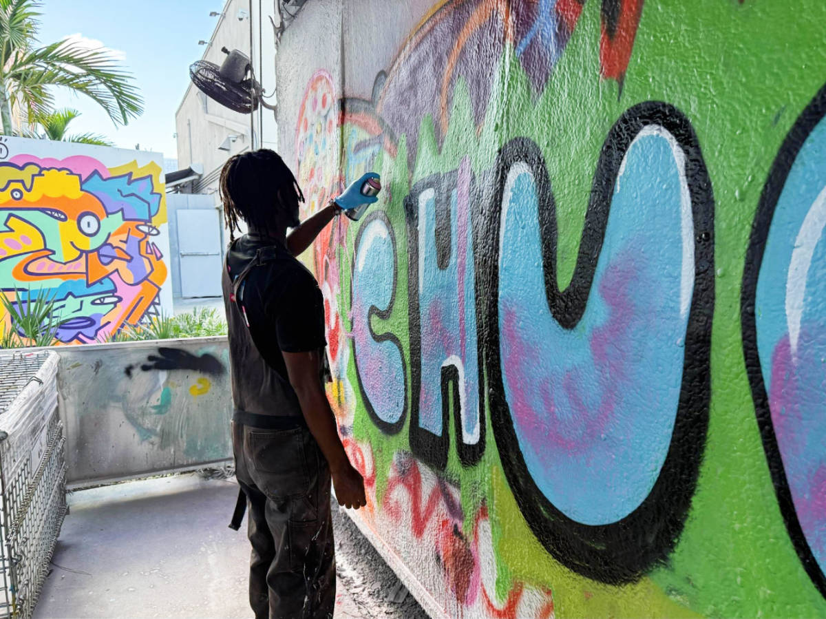 Nate's spray painting instructor doing a tutorial