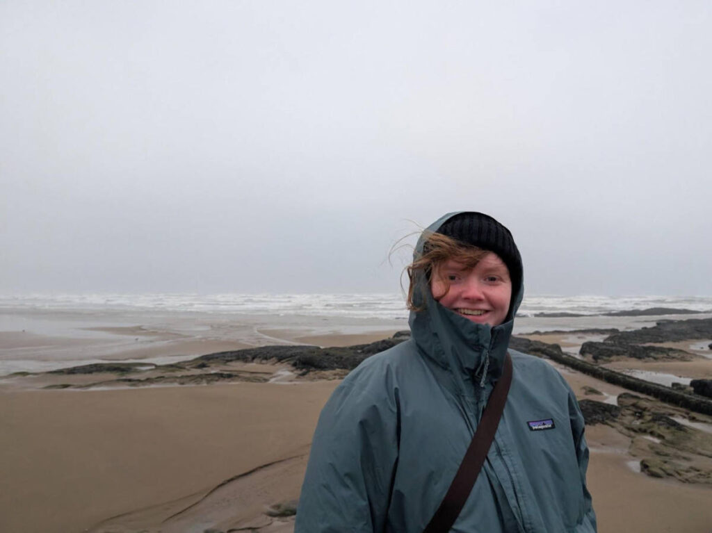The author, Louise Wylie smiling for a photo in St Andrews during winter season