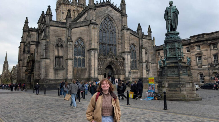 The author Louise Wylie, posing for a photo in front of St Giles’ Cathedral