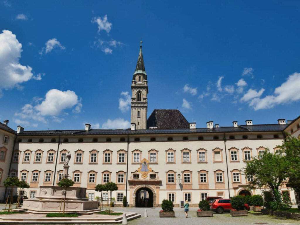 A fountain in front of the St Peter’s Monastery and the clear blue sky above