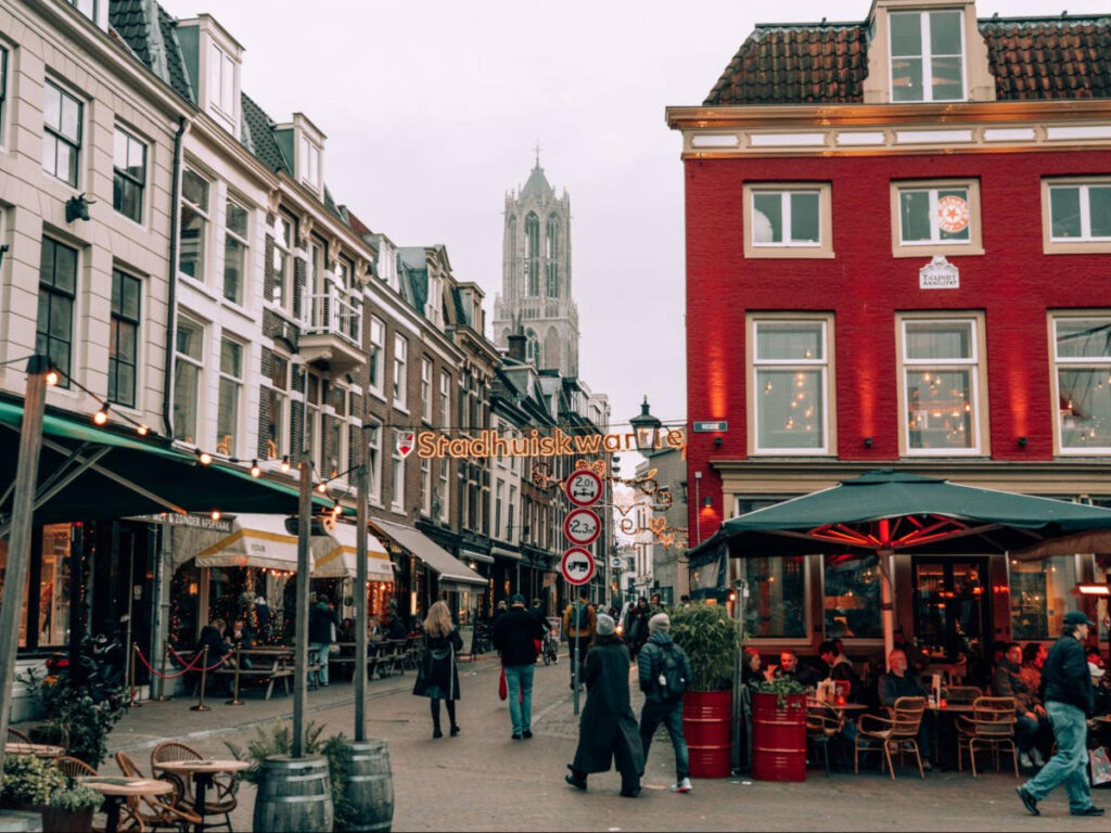 The festive street of Stadhuiskwartier with the Dom Tower in the distance
