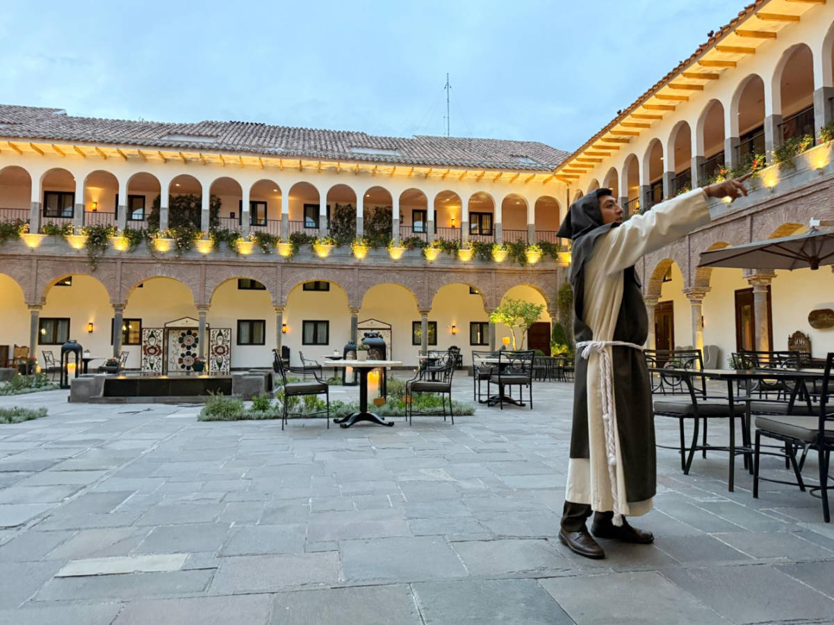 A staff dressed as a monk explaining the history of the JW Marriott El Convento Cusco hotel