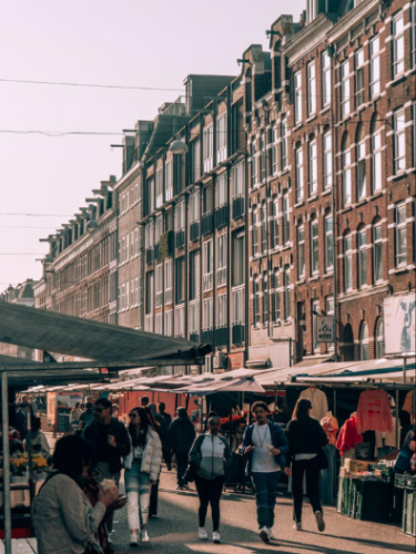 People walking around the stalls in Albert Cuyp Market