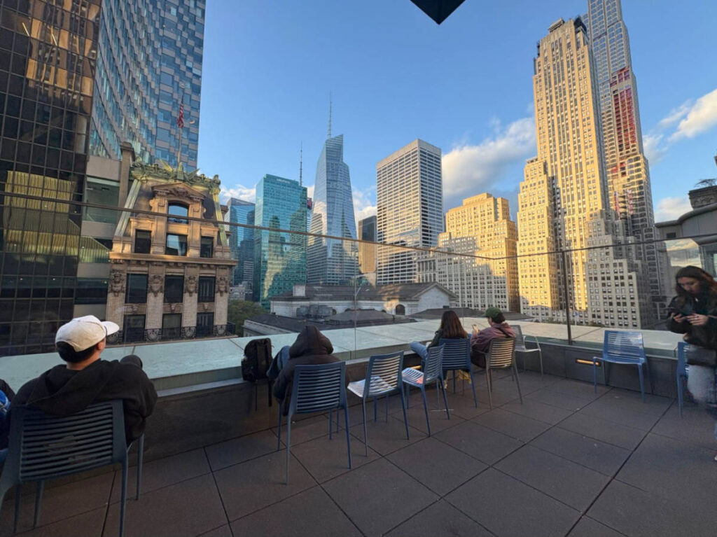 People enjoying the city skyline view from the rooftop terrace of Stavros Niarchos Foundation Library