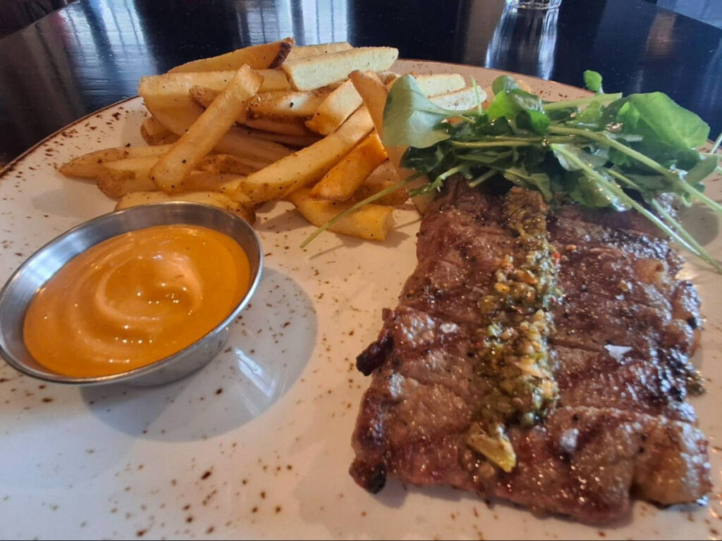 A plate with steak and fries from Charbar
