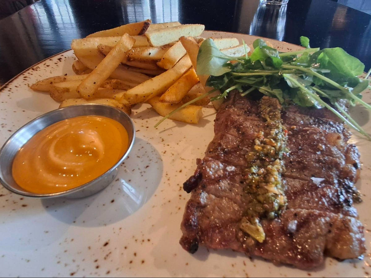 A plate with steak and fries from Charbar