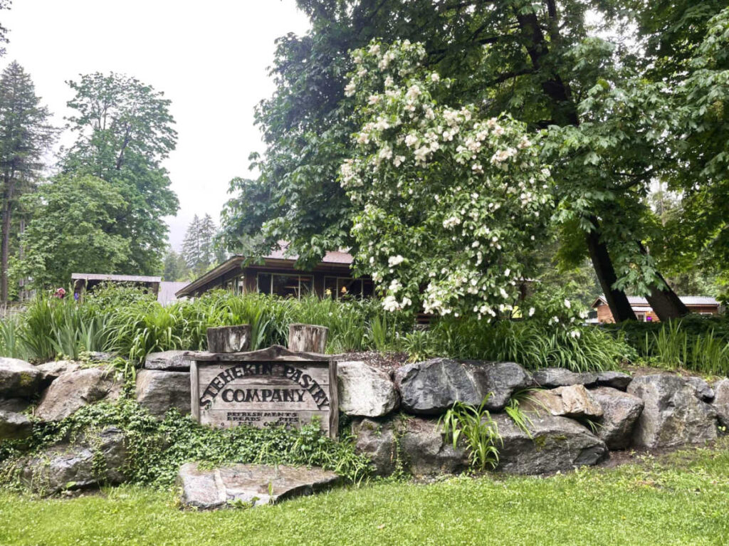 View of the Stehekin Pastry Company signage surrounded by greenery