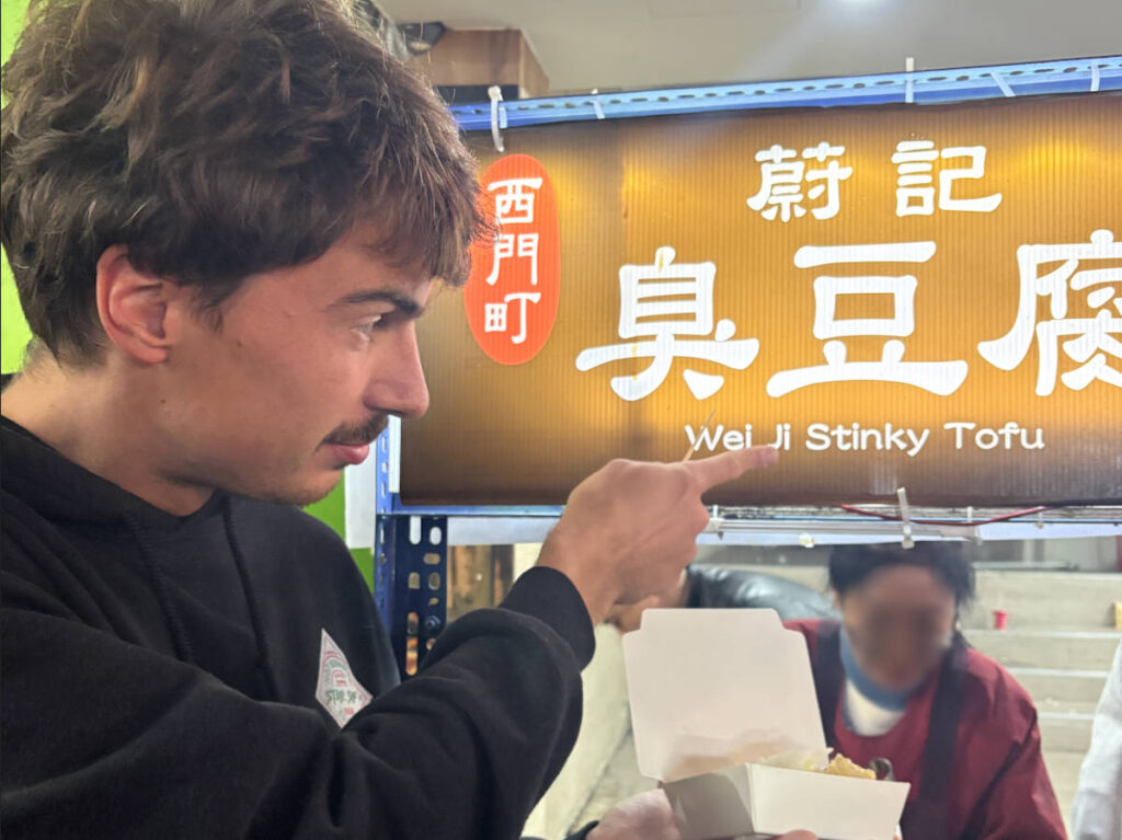 A man holding a Stinky Tofu