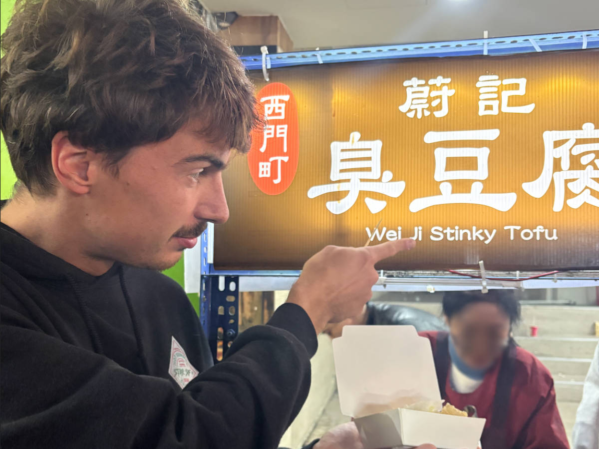 A man holding a Stinky Tofu