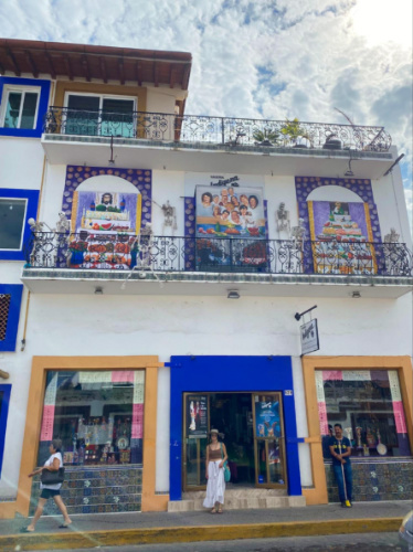 Author McKenna Mobley posing in front of a building on a street