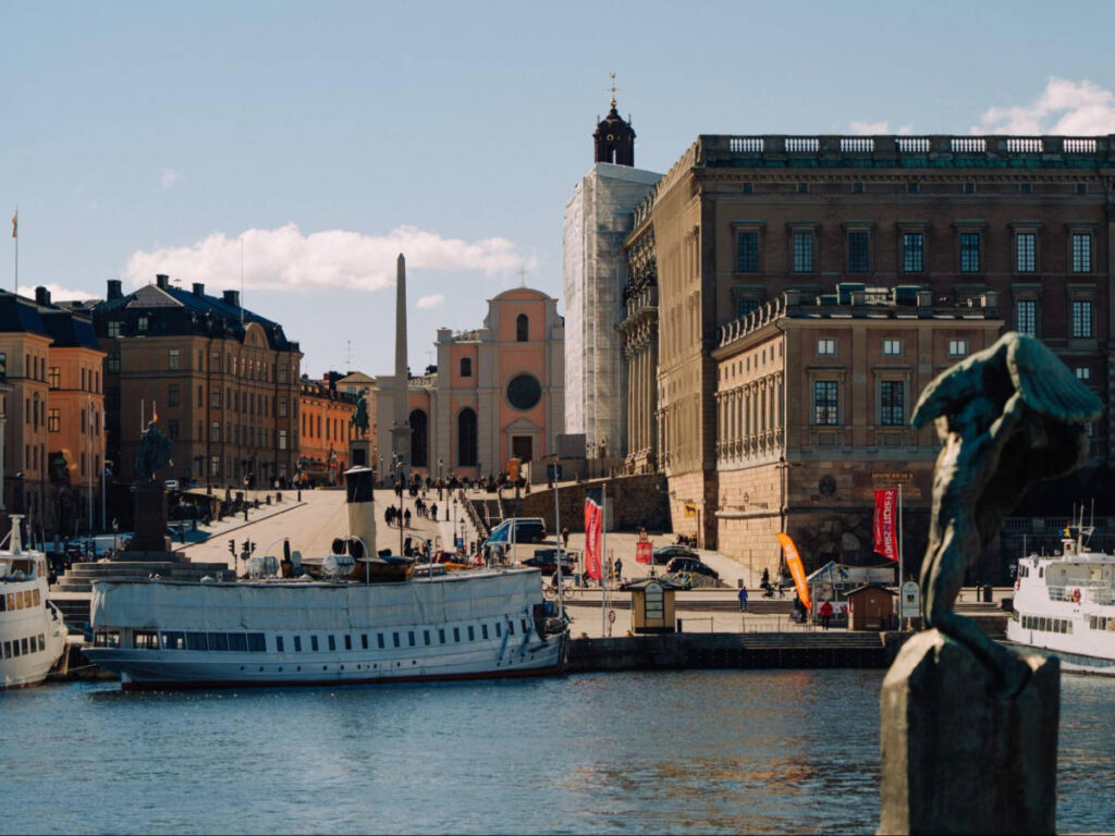 The Storkyrkan peeking from behind the Royal Palace seen across the water