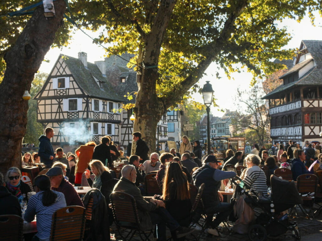 People dining outside under the shade in Strasbourg