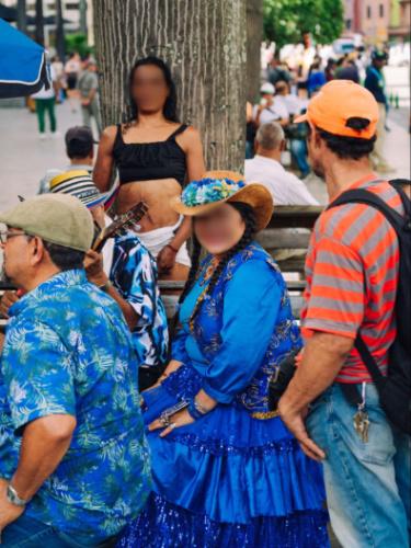 The street performers in blue and the local bystanders in Colombia