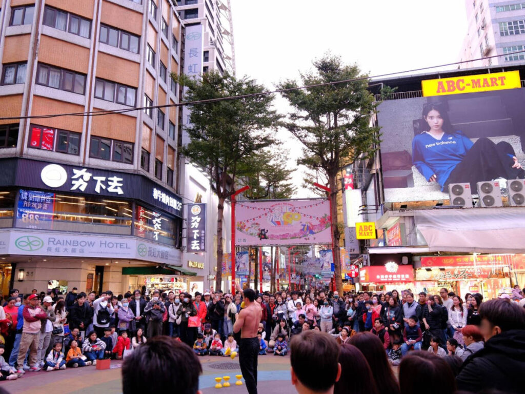 People watching a street performer in Ximending