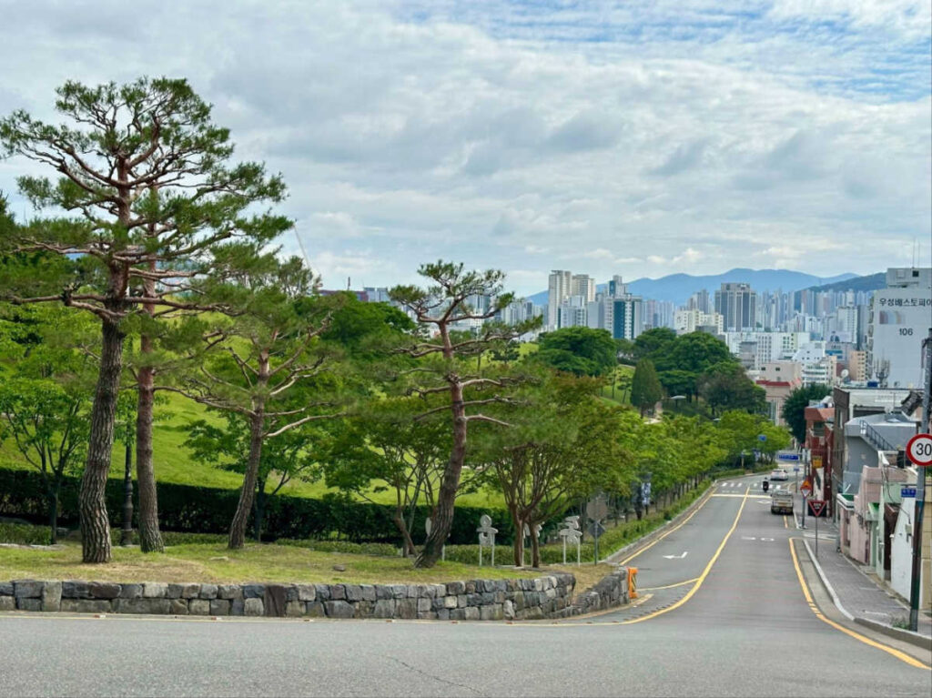 A peaceful street surrounded by greenery in Dongnae