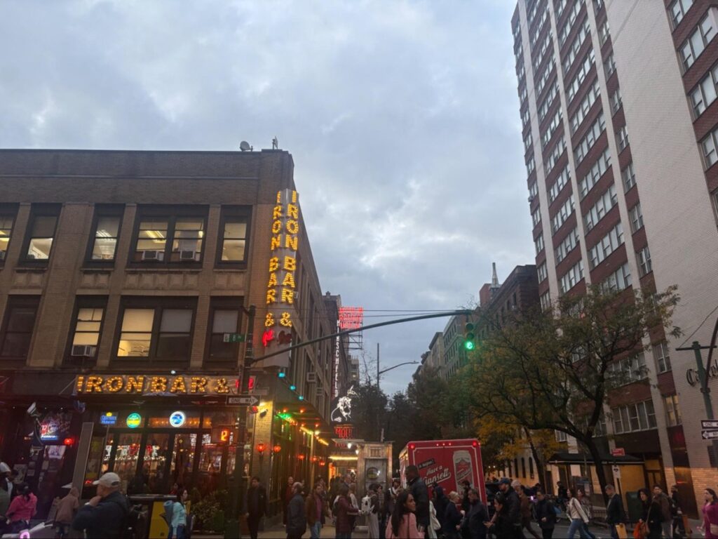 Crowds of people at the streets outside Moulin Rouge