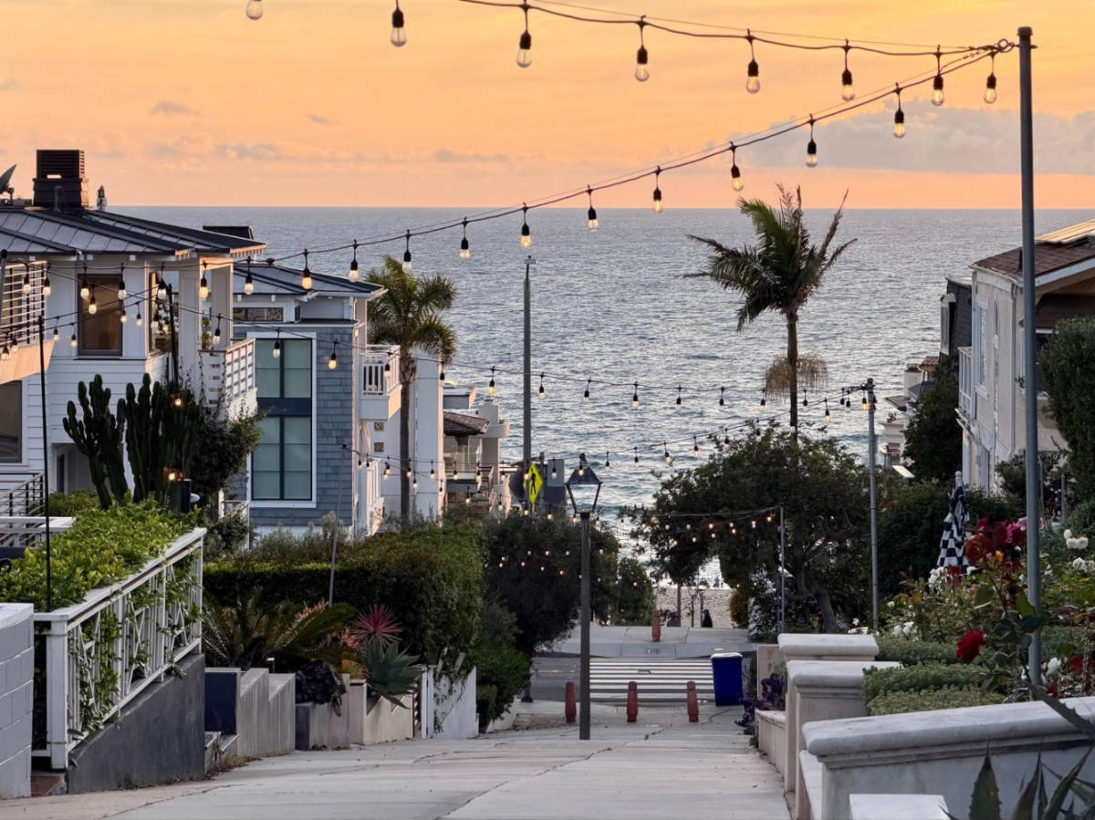 View of the illuminated  string lights along a street in Manhattan Beach at sunset