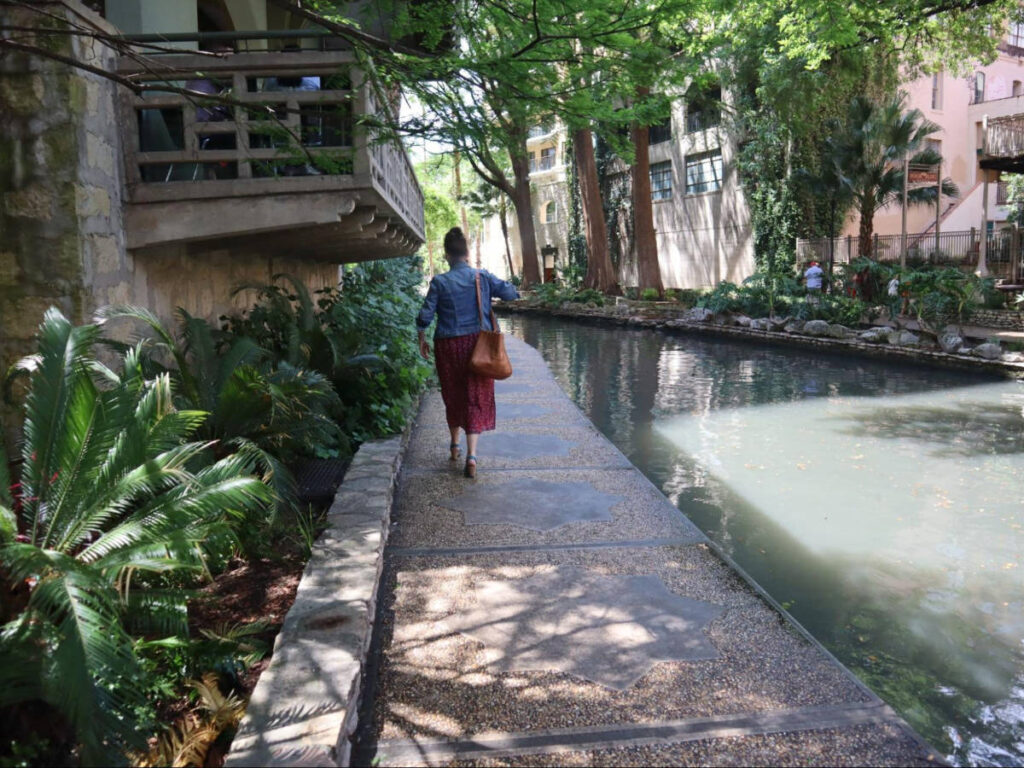 A woman strolling along the river walk