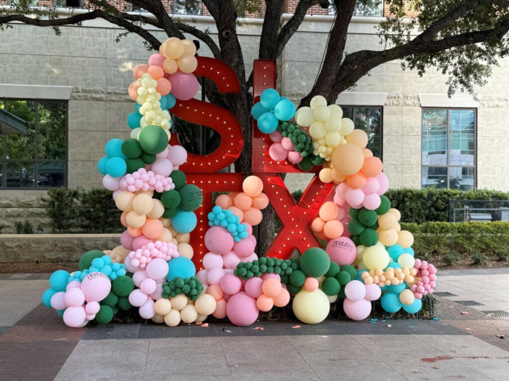 View of the Sugar Land signage with colorful balloons