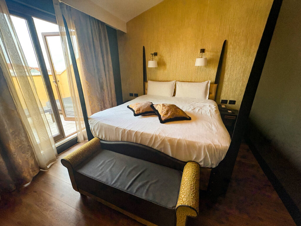 View of the bed and the balcony in Palazzo Veneziano
