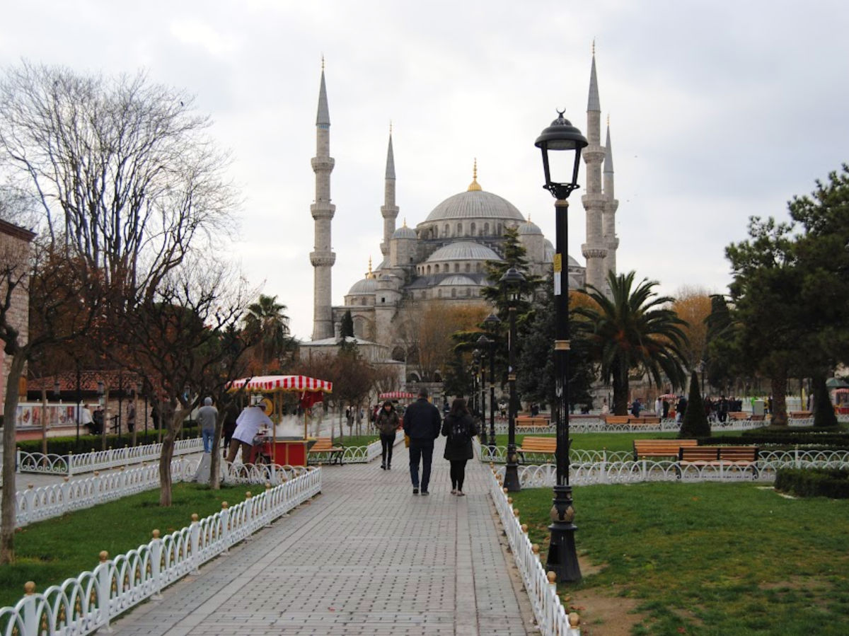 Visitors strolling by the Blue Mosque on a path at Sultanahmet Square