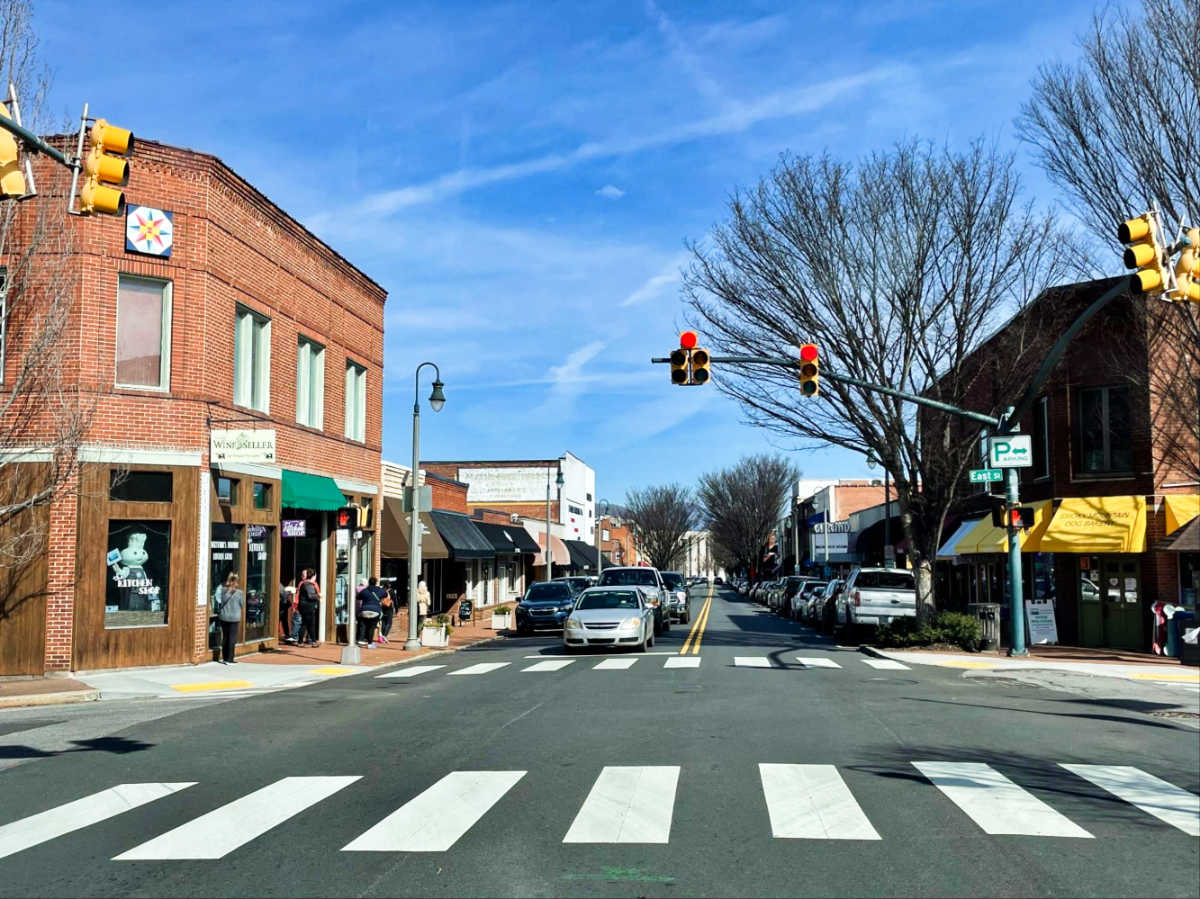 View of the brick walled shops and the vehicles along Downtown Waynesville