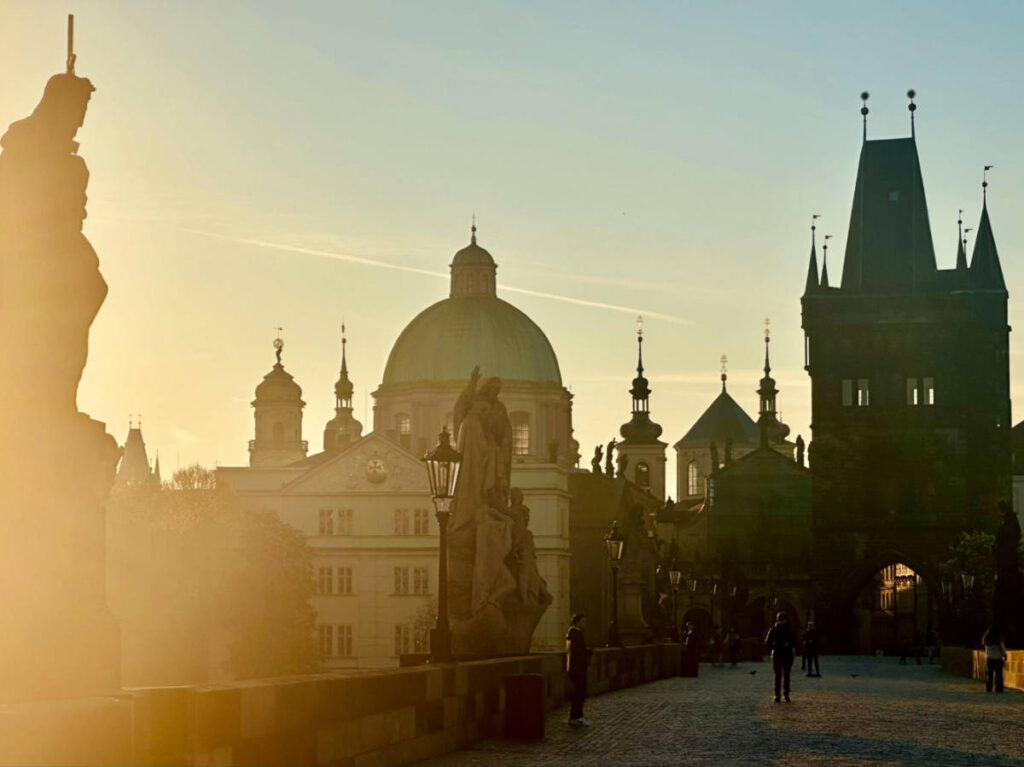 View of the rays of the sunrise at the Charles Bridge