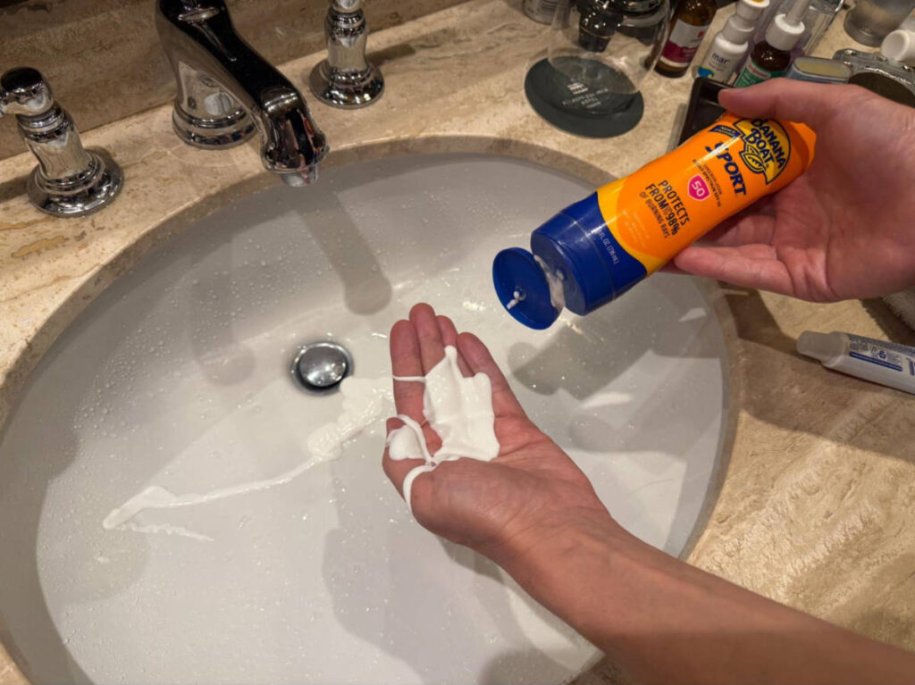The sunscreen liquid squirting out of the bottle