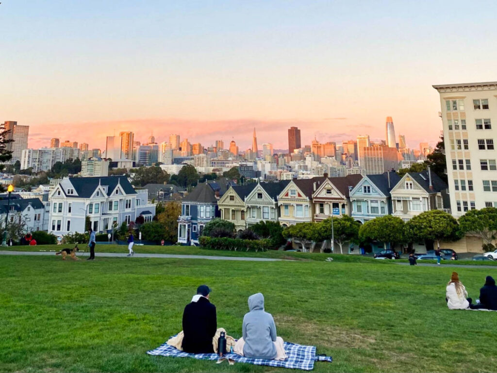 The people enjoying the sunset views at Alamo Square Park