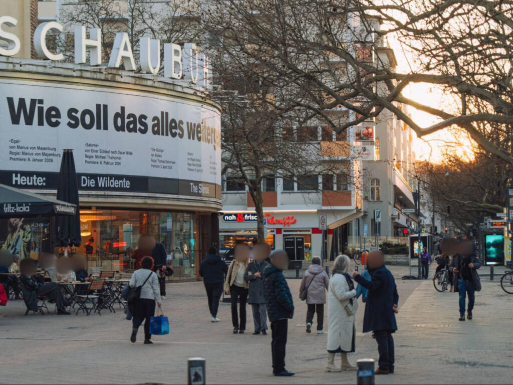 People wandering around Schaubühne at sunset