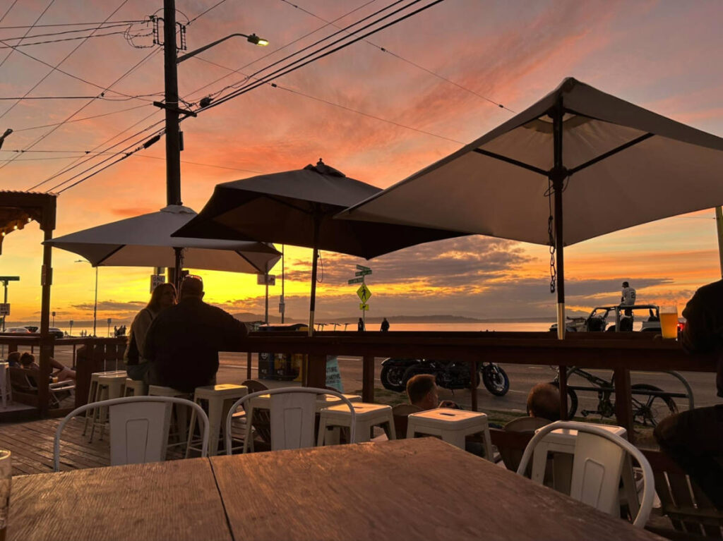 People drinking beers and watching the sunset at Alki Beach