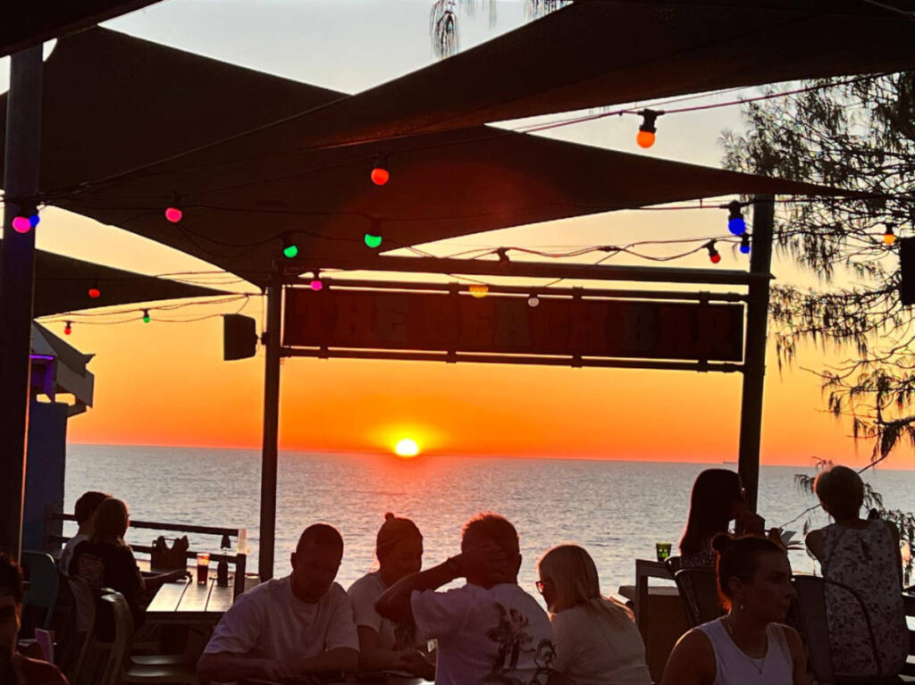 People enjoying the sunset views at Clancy’s Cafe on City Beach