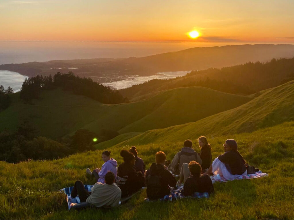 Group of friends having a picnic and viewing the sunset at the hills on Mt. Tamalpais State Park