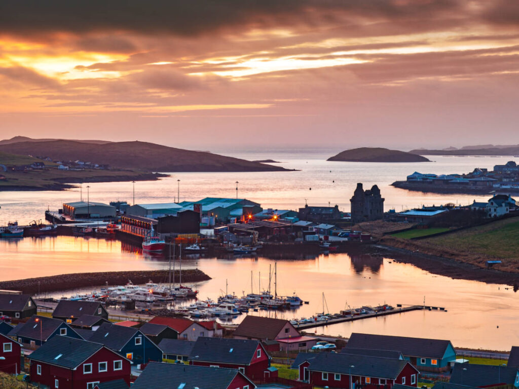 Scenic sunset view over a village on the Shetland Islands